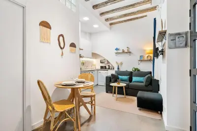 a living room with a table and a couch at Lodging Apartments Almirall Beach B2 in Barcelona