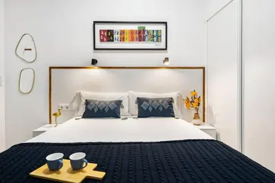 a bedroom with a large bed with two bowls on a tray at Lodging Apartments Almirall Beach B2 in Barcelona