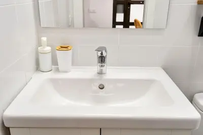 a white sink in a bathroom with a mirror at Lodging Apartments Almirall Beach B2 in Barcelona