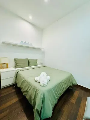 a bedroom with a bed with two towels on it at 45 Center Basic 1 2 in Barcelona