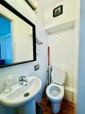 a bathroom with a white toilet and a sink at 45 Center Basic 1 2 in Barcelona