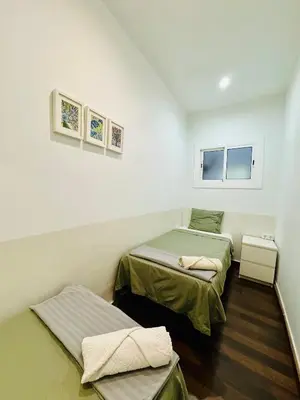 a room with two beds and a window at 45 Center Basic 1 2 in Barcelona