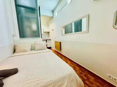 a bedroom with two beds and a window at 044 Velvet 1 3 in Barcelona