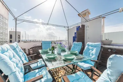 a table and chairs on a balcony with a view at Esencia Mediterránea Precioso en primera linea in Sitges