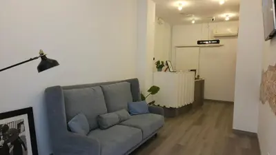 a living room with a couch and a lamp at HeyLola! Hostel in Barcelona