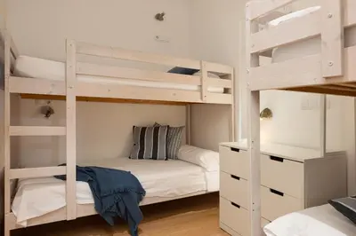 a bedroom with two bunk beds and a desk at Lets Holidays Centric Apartment in Barcelona in Barcelona