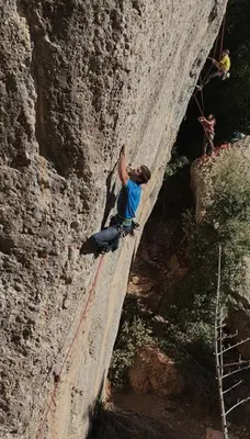a man is climbing a rock wall at Casa Annie in Collbató