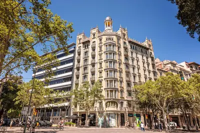 a large white building on a city street at The Diagonal Suites Atic by Sweett in Barcelona