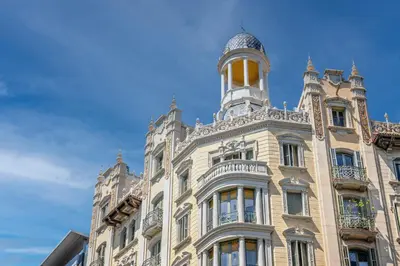 a building with a tower on top of it at The Diagonal Suites Atic by Sweett in Barcelona