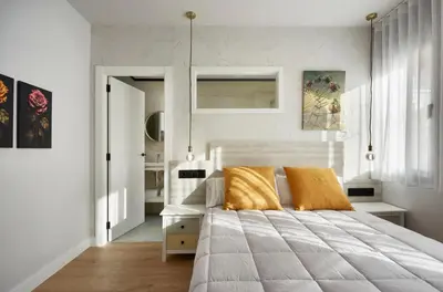 a bedroom with a large bed and white walls at Urban Sabadell 2 in Sabadell