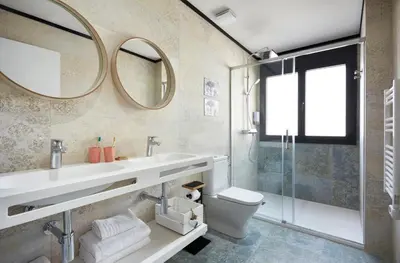 a bathroom with a sink and a toilet and a mirror at Urban Sabadell 2 in Sabadell
