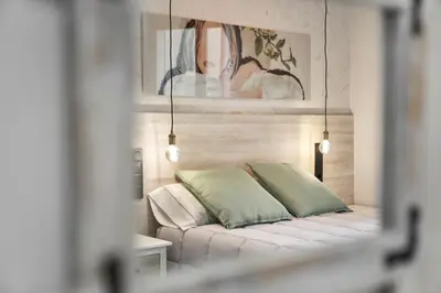 a bedroom with a bed with a painting on the wall at Urban Sabadell 2 in Sabadell