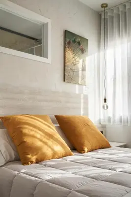 a bed with two pillows on it in a room at Urban Sabadell 2 in Sabadell