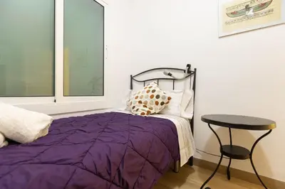 a bedroom with a purple bed and a table at Vincent's House in Barcelona