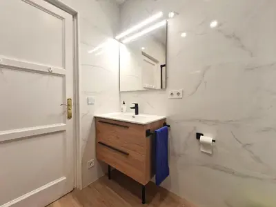 a white bathroom with a sink and a mirror at Vincent's House in Barcelona