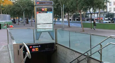a bus stop with a sign in a city at Vincent's House in Barcelona