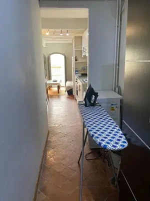a kitchen with a table in the middle of a room at Piso Rustico Calle de la Font Vilafranca del penedes in Vilafranca del Penedès