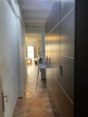 a hallway with a metal door in a room at Piso Rustico Calle de la Font Vilafranca del penedes in Vilafranca del Penedès