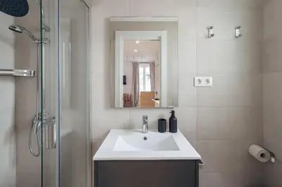 a bathroom with a sink and a shower with a mirror at Casa Atrio - Wonderful studio near Barcelona cathedral in Barcelona