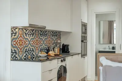 a kitchen with a counter with a washer and dryer at Casa Atrio - Wonderful studio near Barcelona cathedral in Barcelona