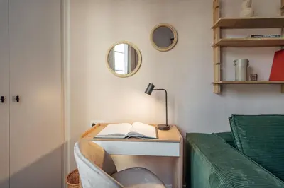 a desk with a book on it next to a couch at Casa Atrio - Wonderful studio near Barcelona cathedral in Barcelona