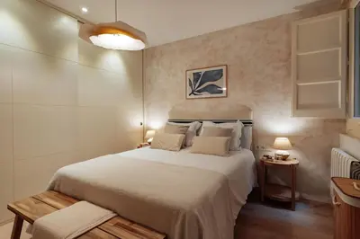 a bedroom with a large white bed in a room at Casa Calders in Barcelona