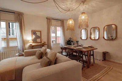 a living room with a couch and a table at Casa Calders in Barcelona