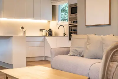 a living room with a couch and a kitchen at Villa Atardecer in Barcelona
