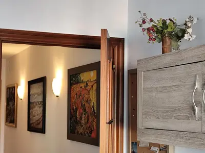 a room with a door and a vase of flowers on the wall at Ca La Dulcet in Gélida