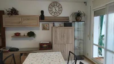a room with a table and a clock on the wall at Ca La Dulcet in Gélida