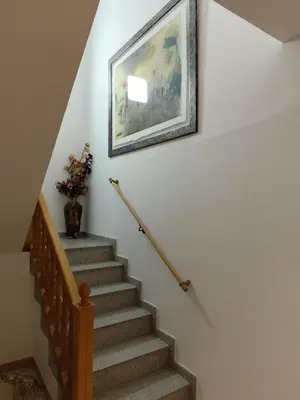 a picture hanging on a wall above a stairway at Ca La Dulcet in Gélida