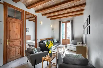 a living room with two couches and a table at Mooeve Sant Antoni in Barcelona