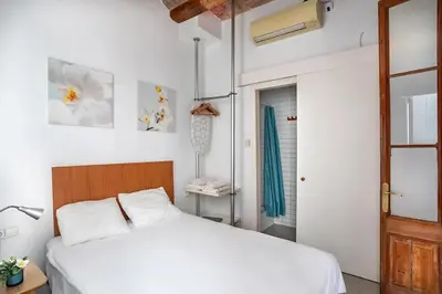 a bedroom with a white bed and a window at Mooeve Sant Antoni in Barcelona