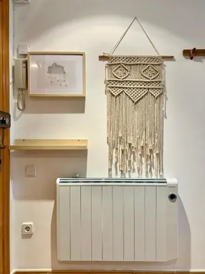 a curtain hanging on a wall next to a radiator at Apartamento Sant Josep in Canet de Mar