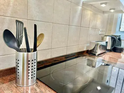a metal container with utensils on a counter in a kitchen at Apartamento Sant Josep in Canet de Mar