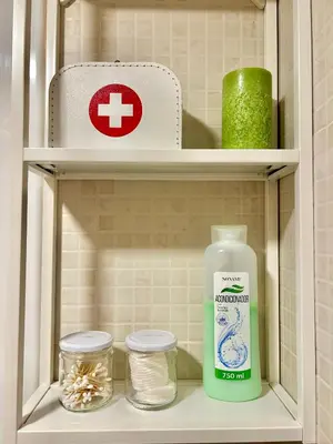 a shelf with a bottle of mouthwash and other items at Apartamento Sant Josep in Canet de Mar