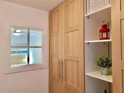 a room with a door and a window and a shelf at Apartamento Sant Josep in Canet de Mar