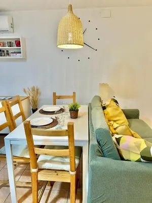 a living room with a couch and a dining room table at Apartamento Sant Josep in Canet de Mar