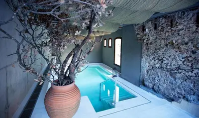 a large vase sitting next to a swimming pool at Mas Salagros EcoResort & SPA in Vallromanas