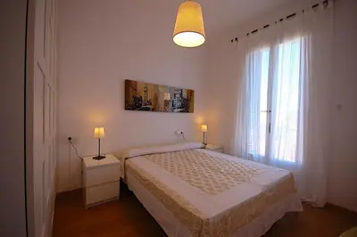 a bedroom with a bed and a large window at Lets Holidays Apartment Barcelona near beach in Barcelona