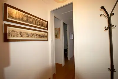 a hallway with a painting on the wall and a hallway sidx sidx at Lets Holidays Apartment Barcelona near beach in Barcelona