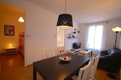 a dining room and living room with a black table at Lets Holidays Apartment Barcelona near beach in Barcelona