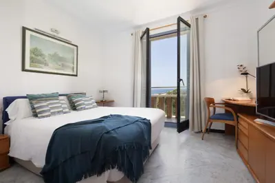 a bedroom with a bed and a television and a window at Lets Holidays Apartment Sea Views in Barcelona in Barcelona