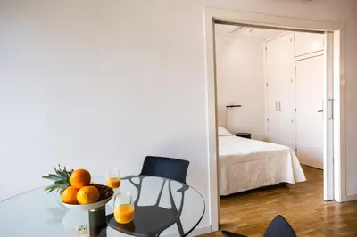 a room with a table with oranges and a chair at Suitur apartamento exclusivo céntrico Barcelona in Barcelona