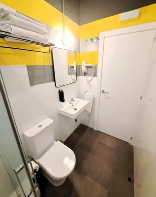 a bathroom with a white toilet and a sink at Bed & Bike Barcelona in Barcelona