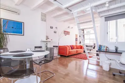 a living room with a table and a ladder at Terrace Duplex at Sagrada Familia by PriorityVillas in Barcelona
