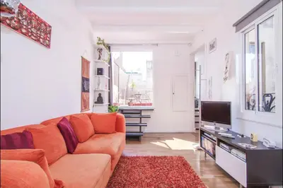 a living room with a couch and a tv at Terrace Duplex at Sagrada Familia by PriorityVillas in Barcelona