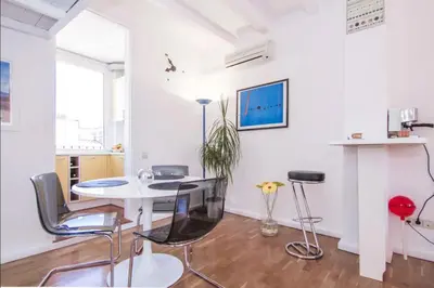 a white room with a table and chairs at Terrace Duplex at Sagrada Familia by PriorityVillas in Barcelona