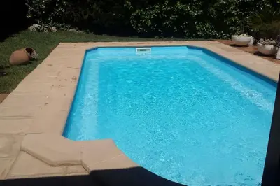 a garden with a small house and a small tree at Beach villa with pool and near BCN & TGN in Cunit