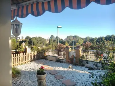 a backyard with a fence and a gravel yard at Beach villa with pool and near BCN & TGN in Cunit